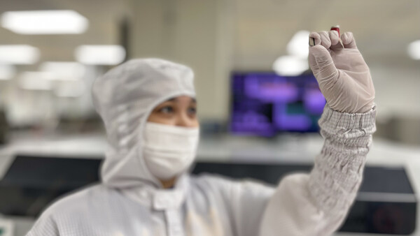 Texas Instruments employees inspect finished GaN chips